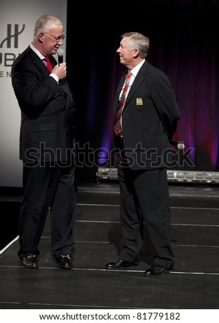 NEW YORK CITY - JULY 25: Hugh Hildesley (L) & Sir Alex Ferguson conduct auction at Hublot \'Art of Fusion\' fashion show with Sir Alex Ferguson & Manchester United at Cipriani Wall Street on July 25, 2011 in New York City, NY