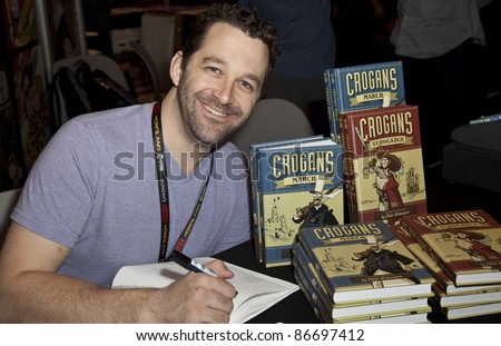 NEW YORK - OCTOBER 15: Author Chris Schweizer signs autograph during New York Comic Con 2011 in Javits Center on October 15, 2011 in New York.