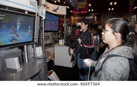 NEW YORK - OCTOBER 15: Unidentified participants try new games for Wii console New York Comic Con 2011 in Javits Center on October 15, 2011 in New York.