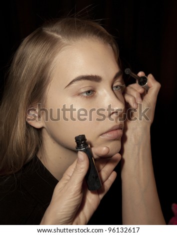 NEW YORK - FEBRUARY 11: Model prepares backstage for Vantan Tokyo collection during Fashion week at Lincoln Center in Manhattan on February 11, 2012 in New York City