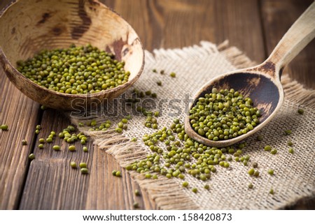 Chinese beans in wooden bowl on wooden surface. Eco product.