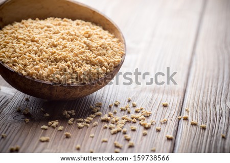 Soy wooden bowl on a wooden surface, eco product.