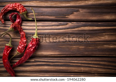 Red chili peppers on a wooden background. The menu background.