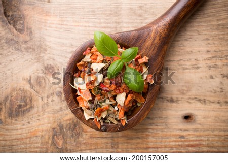 Spice mix a wooden spoon on a wooden background.