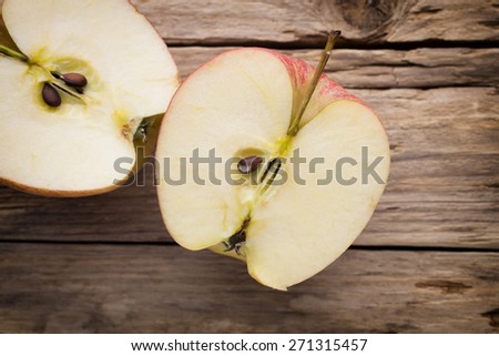 Apple on the wooden background.