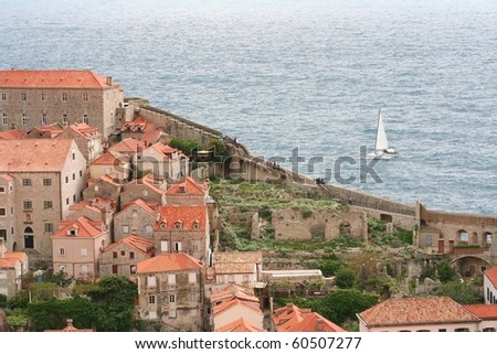 Dubrovnik Croatia, old town wall with sailing boat on the other side