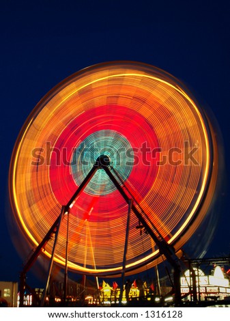 Long exposure of a ferris wheel at a carnival.