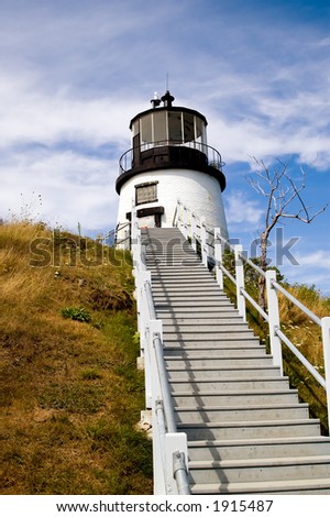 A flight of stairs leads up to the hilltop where the Owls Head Lighthouse stands guard over Penobscot Bay, Maine, near Rockland.