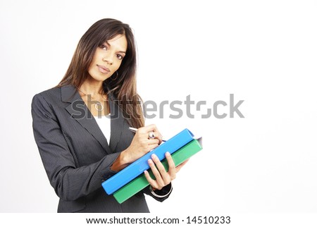 Beautiful brunette woman in pinstripe suit holding her files while wrighting. Isolated on white background with copy space