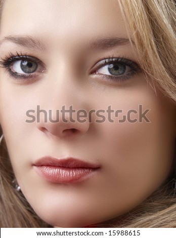 Portrait of a beautiful blonde woman with dark blue eyes and natural make-up