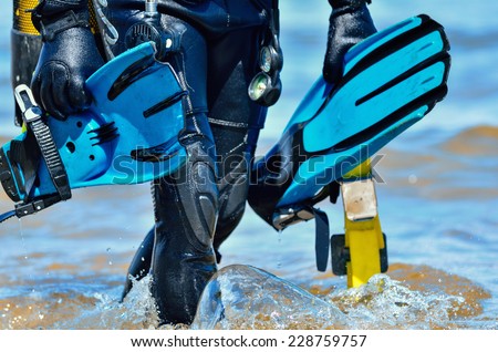Scuba diver after the dive is beached