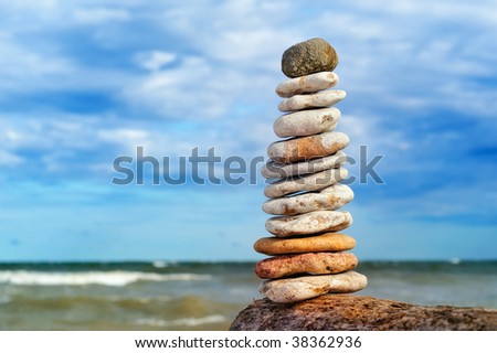 Stone stack of pebble  against sea and sky on the coast