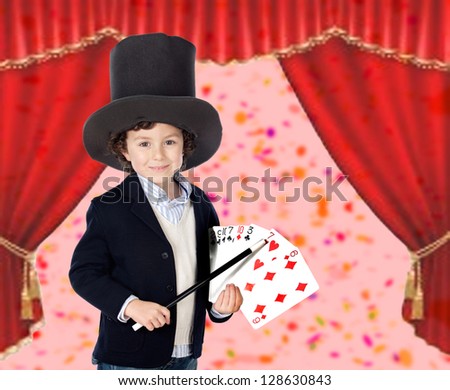 Young magician doing a card trick in a theater