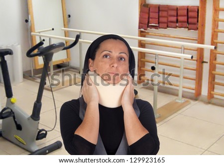 Woman with cervical collar in rehabilitation room