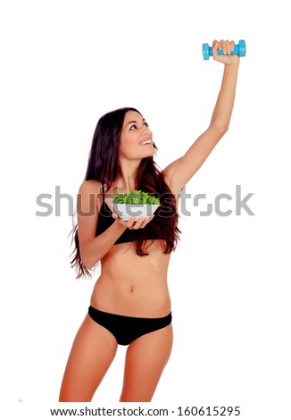 Girl in white underwear with a salad and exercising with dumbbells isolated