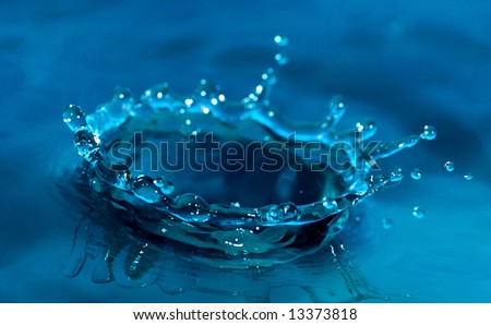 Sparks of blue water on a blue background