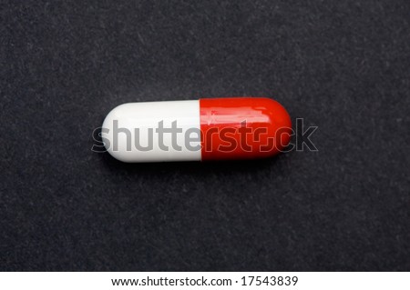 Red and white pill a over black background