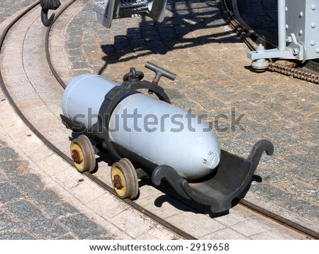 very big gun shell in its transport cart