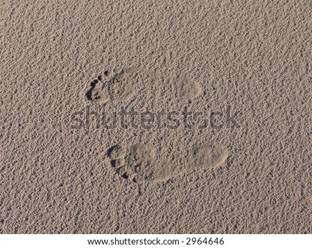 background of child foot prints in the sand