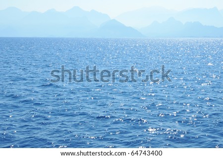 Wave background on a sea with Mountain massive on a horizont