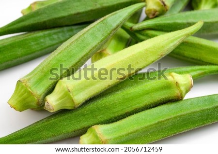 Wellbeing diet, nutritious groceries and healthiness alimentation concept with many green okra vegetables isolated on white background Imagine de stoc © 