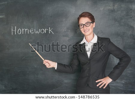 Smiling teacher with pointer and phrase Homework