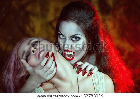 Beautiful vampire woman and her victim
