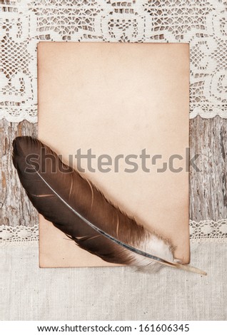 Aged paper, feather and linen fabric
