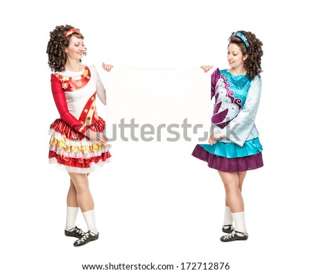 Two young women in irish dance dresses with empty paper