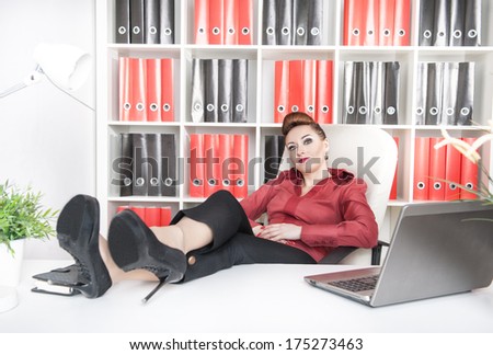 Business woman relax with legs on the table