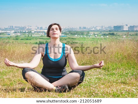 Beautiful plus size woman doing yoga