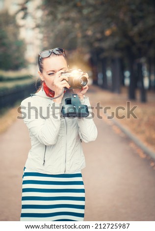Beautiful woman with old retro camera