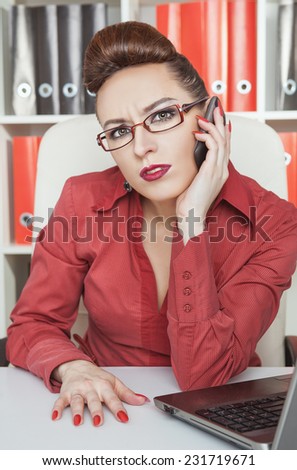 Serious business woman using mobile phone