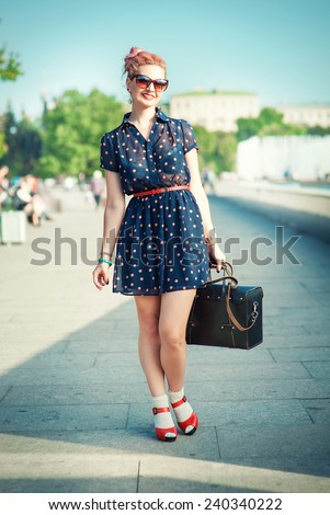 Beautiful young woman in fifties style with braces smiling outdoor