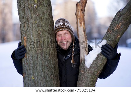 Happy man hugging the tree