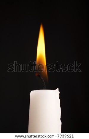 Isolated candle stick with light over a black background