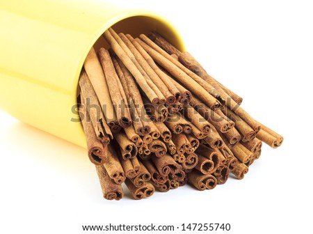 cinnamon sticks in a yellow cup