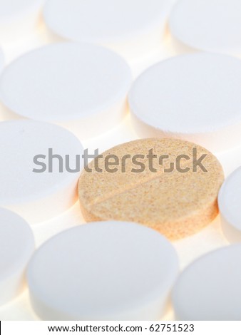 white big pills background - one pill stand out others