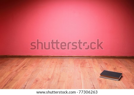 book to lie in floor red wall background