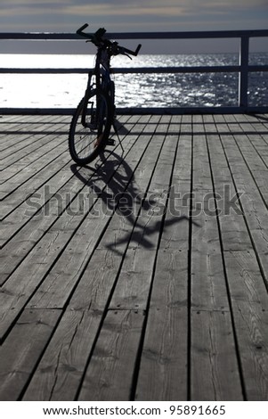 Bike at the pier, jetty in morning sea