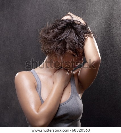 Portrait of beautiful young woman with shirt on black background. Studio photos. Fine spray of water. Post production - without styling filters.
