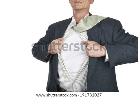 Businessman showing blank superhero suit underneath his shirt standing against city white background