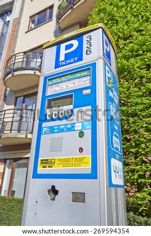 BRUSSELS, BELGIUM - APRIL 15, 2015:  Brussels powered solar parking meter. Parking solutions have been growing in importance to deal with increasing congestion of parking spaces.