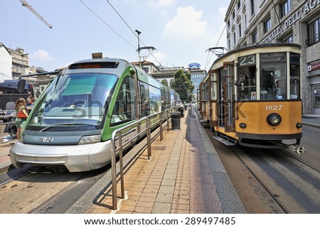 MILAN, ITALY- JUNE 11, 2015: Milan Orange Cable Car and Modern Street car ready for departure on subway platform in Milan, Italy . Symbol of mobility, ecology and alternative energy