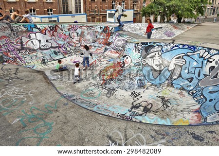 BRUSSELS, BELGIUM -18 JULY 2015: Some children playing in the bowl at the skate park in central Brussels.The Ursulines square is a public open square in skateboarding, BMX, inline skating, etc.