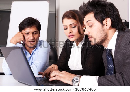 business meeting, young Indian woman sharing ideas with her coworkers