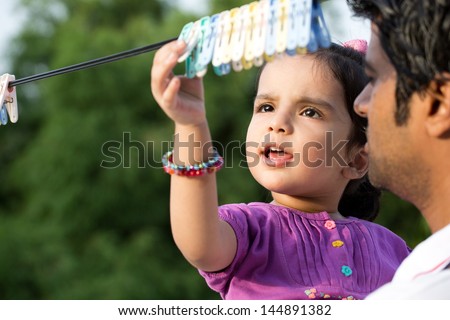 happy father and dauther in the outdoors, Indian man with his two year old daughter
