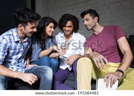 group of friends reading a message on smart phone.