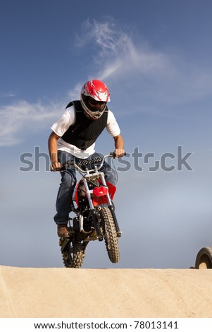 man doing a stunt on trail bike on dirt track