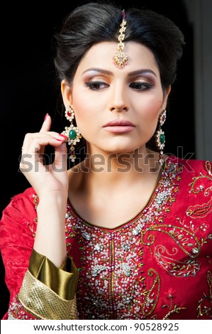 Muslim Indian bride wearing a red bridal dress, portrait of a beautiful Indian bride